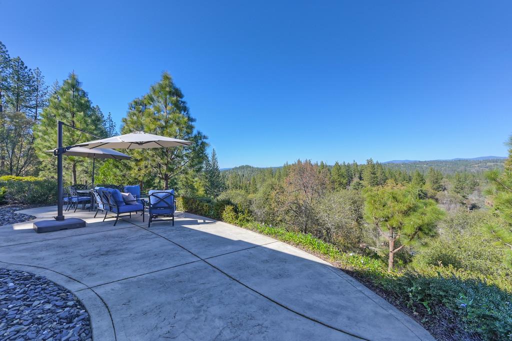3254 Clark Street Placerville, CA 95667 - Photo 7 of 45 a view of a backyard with chair and table under an umbrella