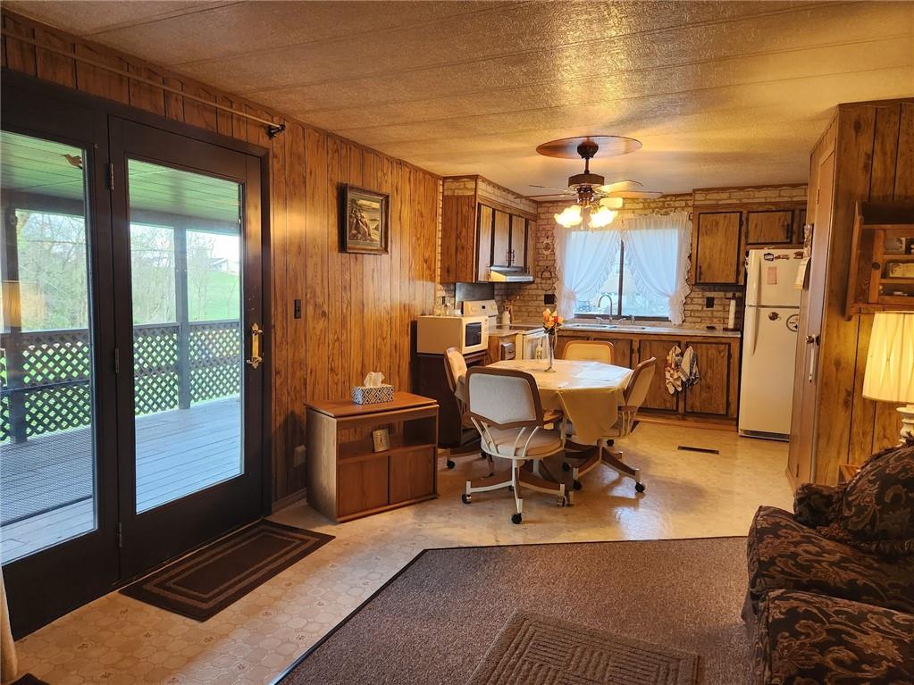 935 Rockdale Road Butler, PA 16002 - Photo 12 of 34 a living room with furniture a flat screen tv and floor to ceiling window