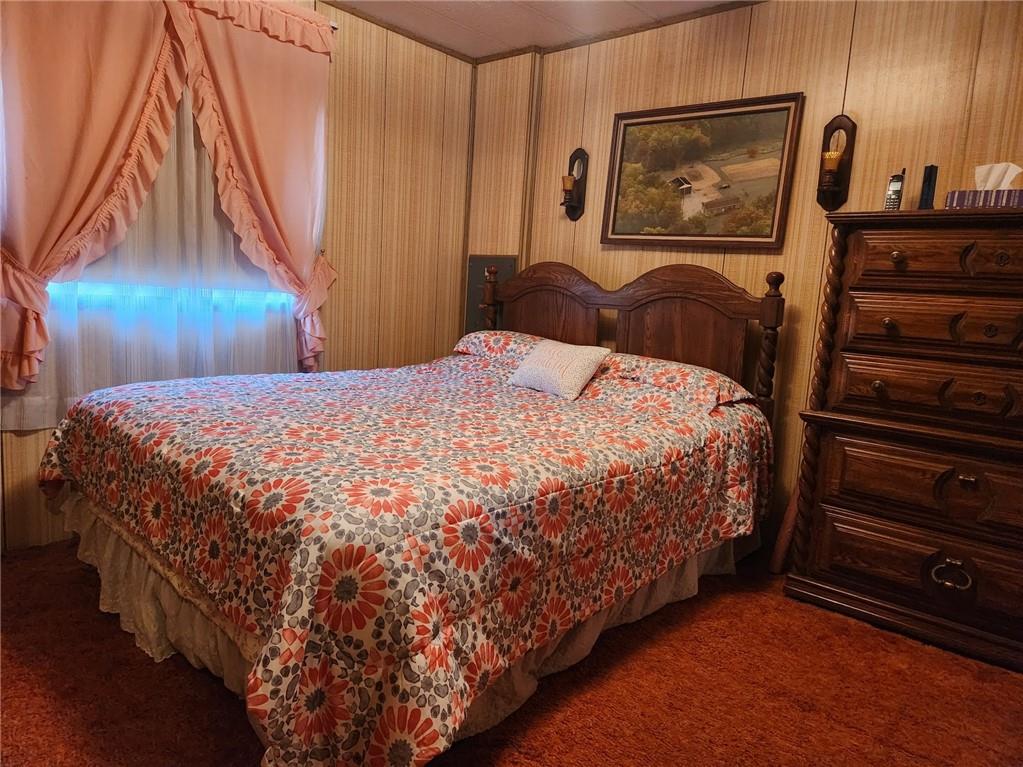 935 Rockdale Road Butler, PA 16002 - Photo 17 of 34 a bedroom with a bed and a chandelier