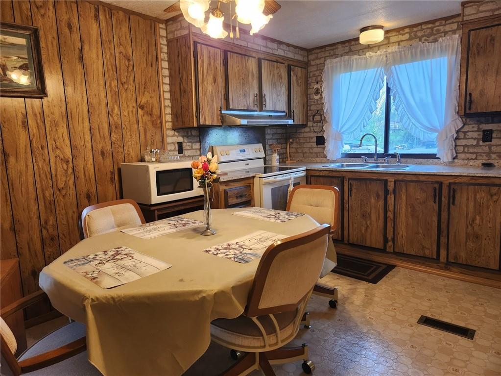935 Rockdale Road Butler, PA 16002 - Photo 9 of 34 a kitchen with granite countertop a dining table chairs sink and cabinets