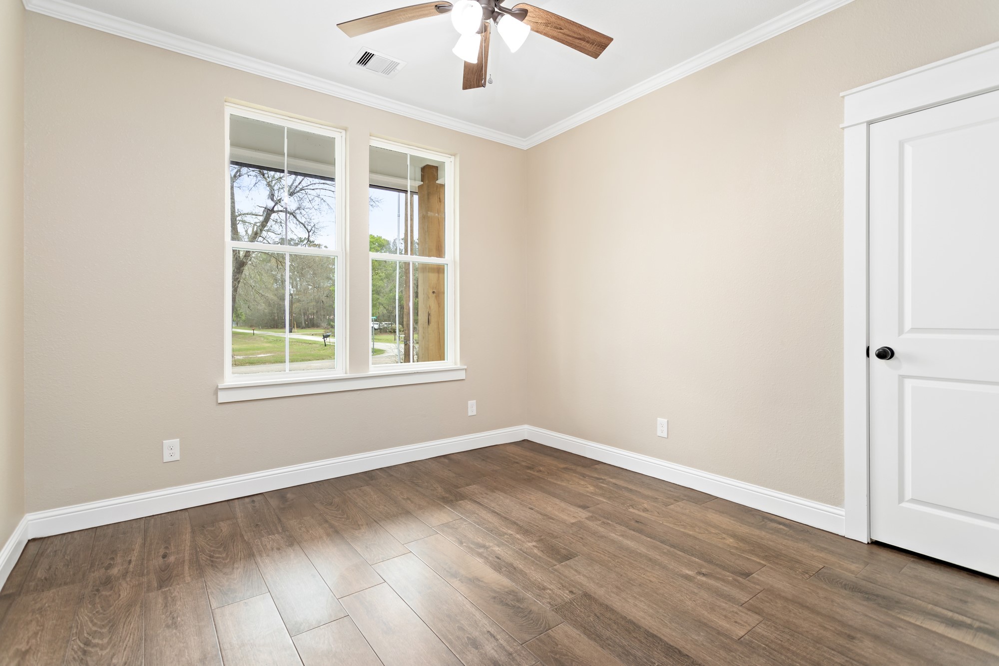 1130 Lyndale Street Vidor, TX 77662 - Photo 21 of 44 a view of an empty room with wooden floor and a window