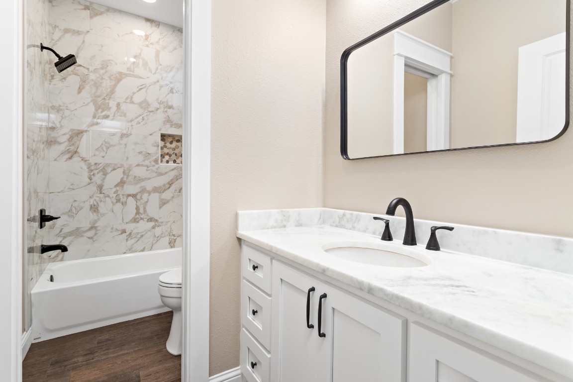 1130 Lyndale Street Vidor, TX 77662 - Photo 23 of 44 a bathroom with a granite countertop sink a mirror and a bathtub