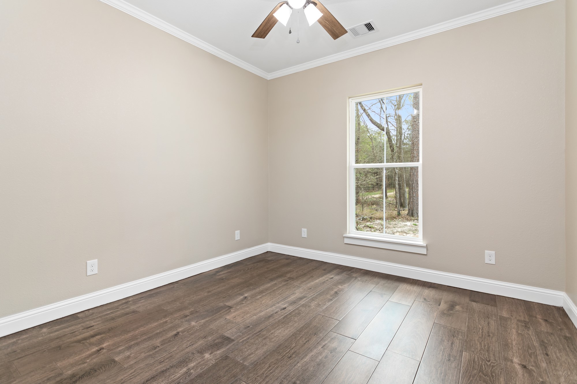 1130 Lyndale Street Vidor, TX 77662 - Photo 25 of 44 an empty room with wooden floor and windows