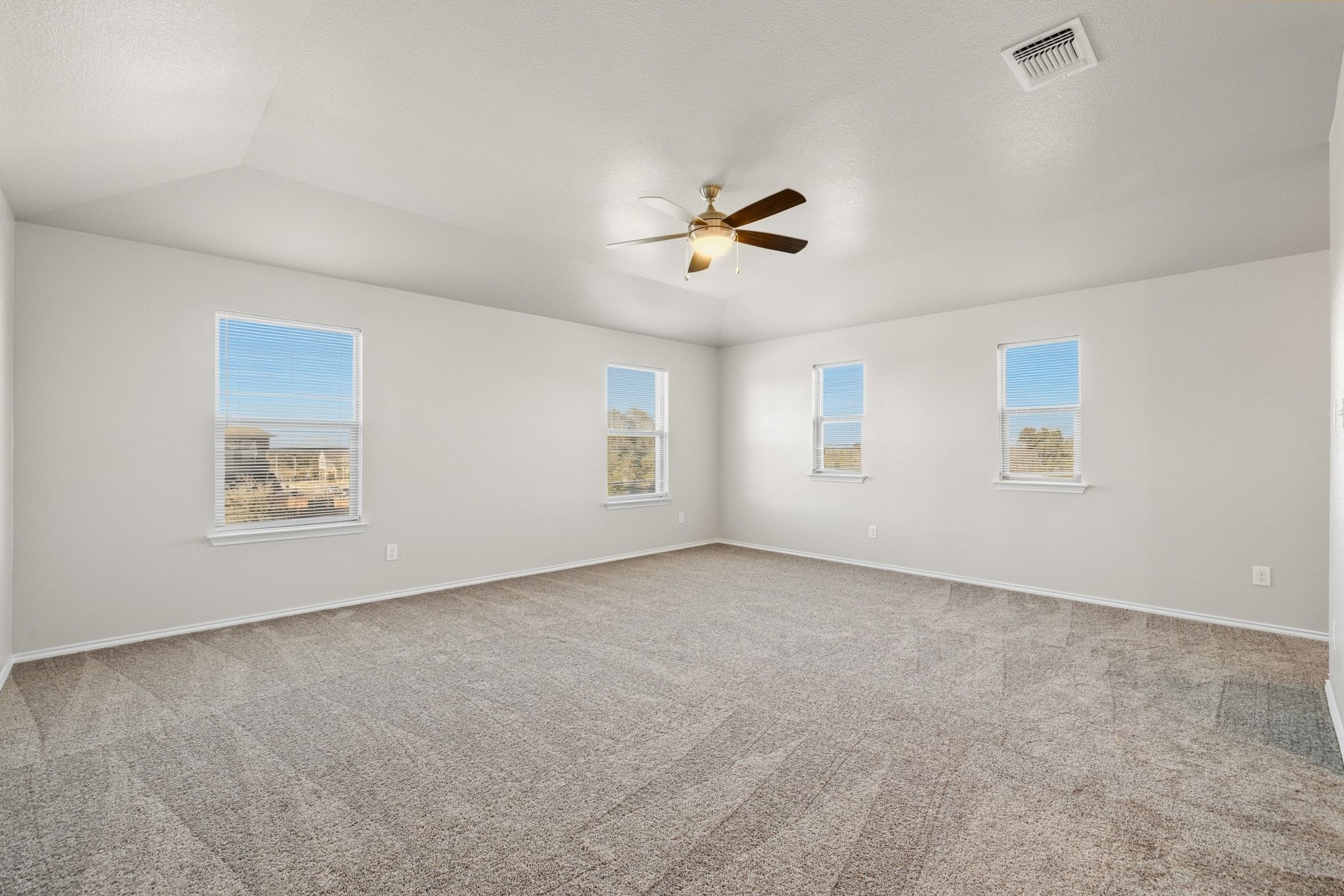 1829 Stringer Pass Leander, TX 78641 - Photo 19 of 36 Unfurnished room with light carpet, a ceiling fan, and plenty of natural light
