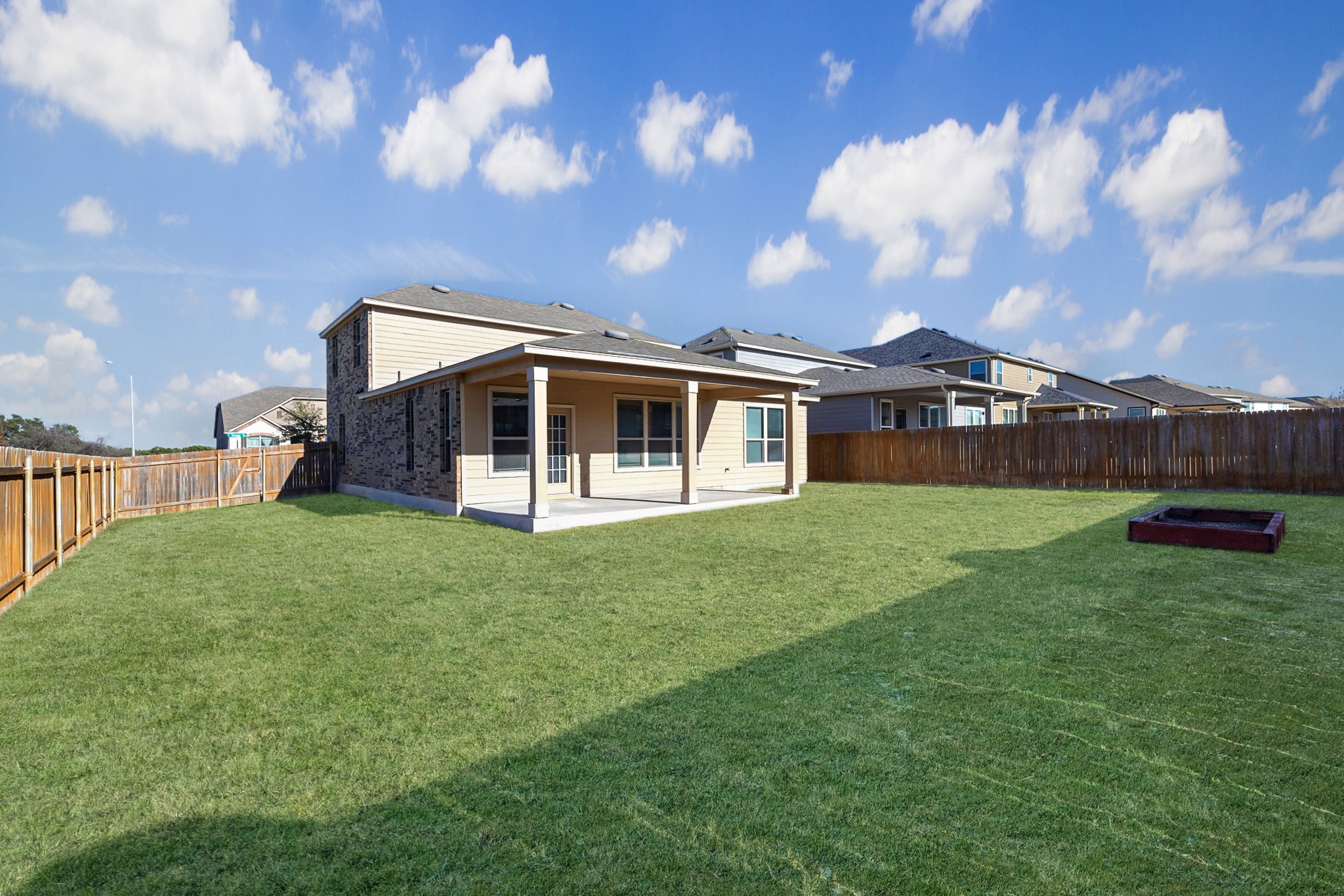 1829 Stringer Pass Leander, TX 78641 - Photo 27 of 36 Back of house with a patio and a fenced backyard