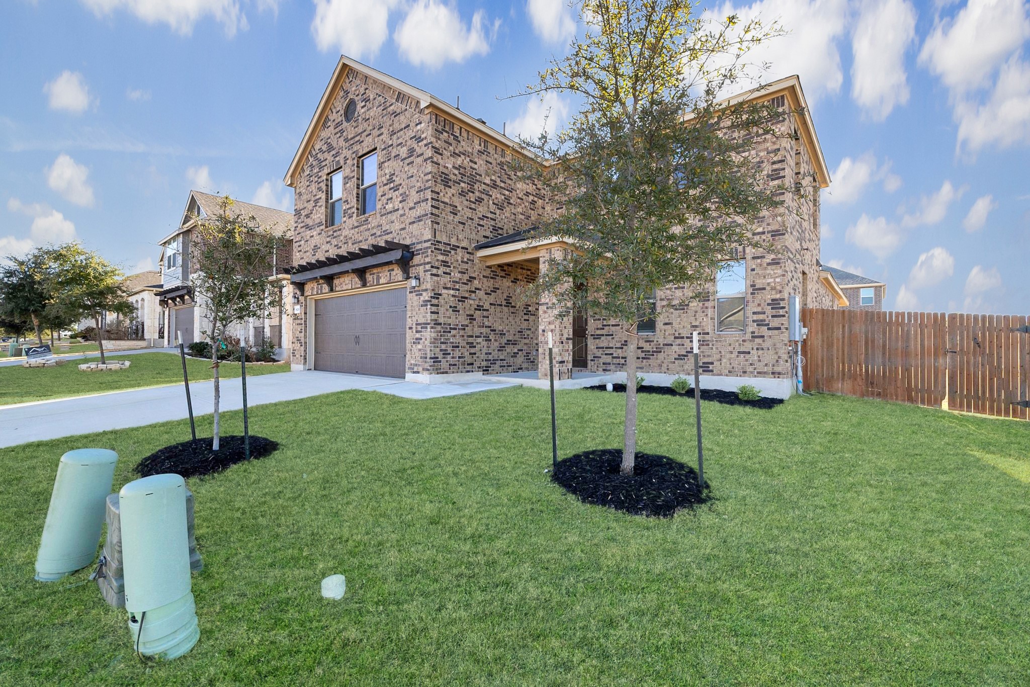 1829 Stringer Pass Leander, TX 78641 - Photo 3 of 36 View of front of home with an attached garage, concrete driveway, and brick siding