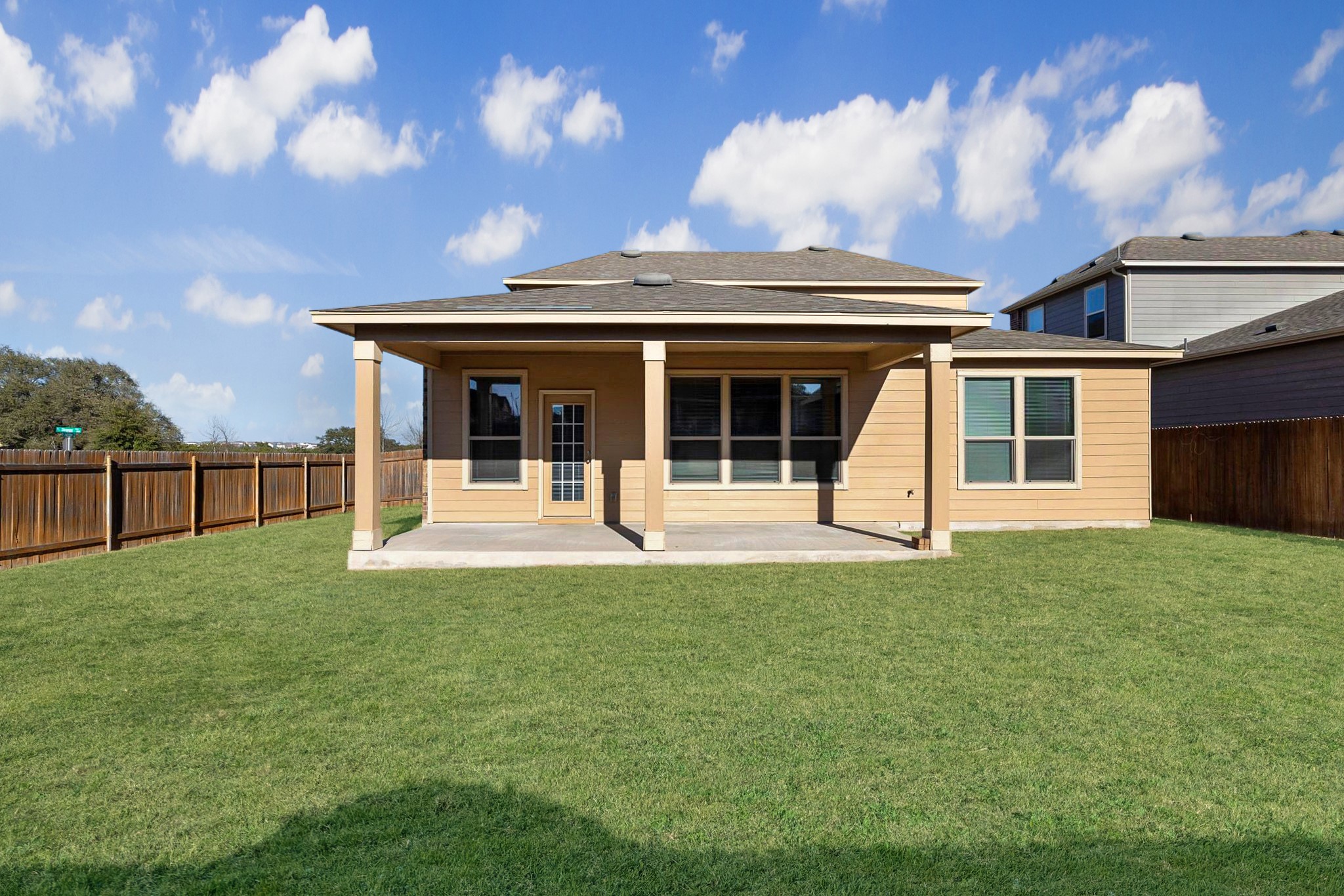 1829 Stringer Pass Leander, TX 78641 - Photo 28 of 36 Rear view of house with a patio area, a fenced backyard, and a shingled roof