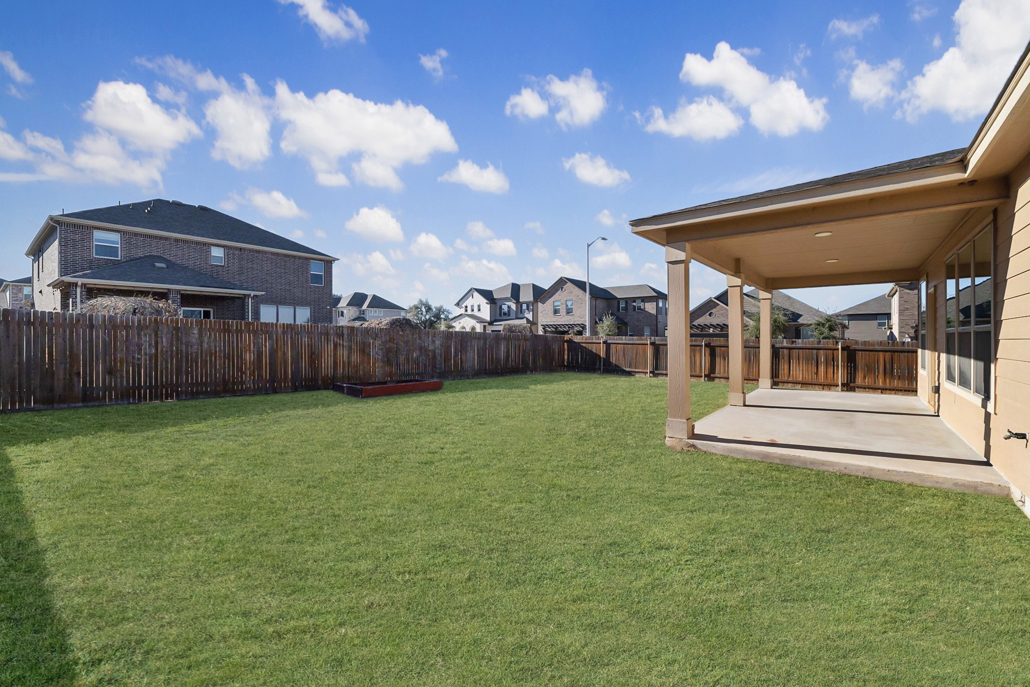 1829 Stringer Pass Leander, TX 78641 - Photo 29 of 36 Fenced backyard with a residential view and a patio