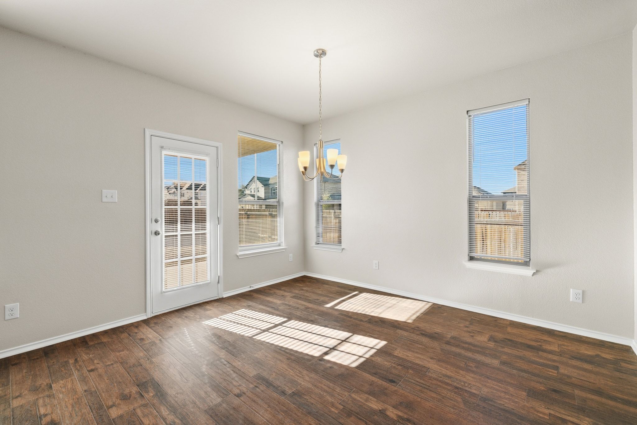 1829 Stringer Pass Leander, TX 78641 - Photo 9 of 36 Unfurnished dining area with hanging lights and dark wood-style flooring