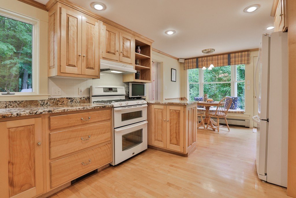 74 River Road Merrimac, MA 01860 - Photo 13 of 29 a kitchen with granite countertop a stove top oven sink and cabinets