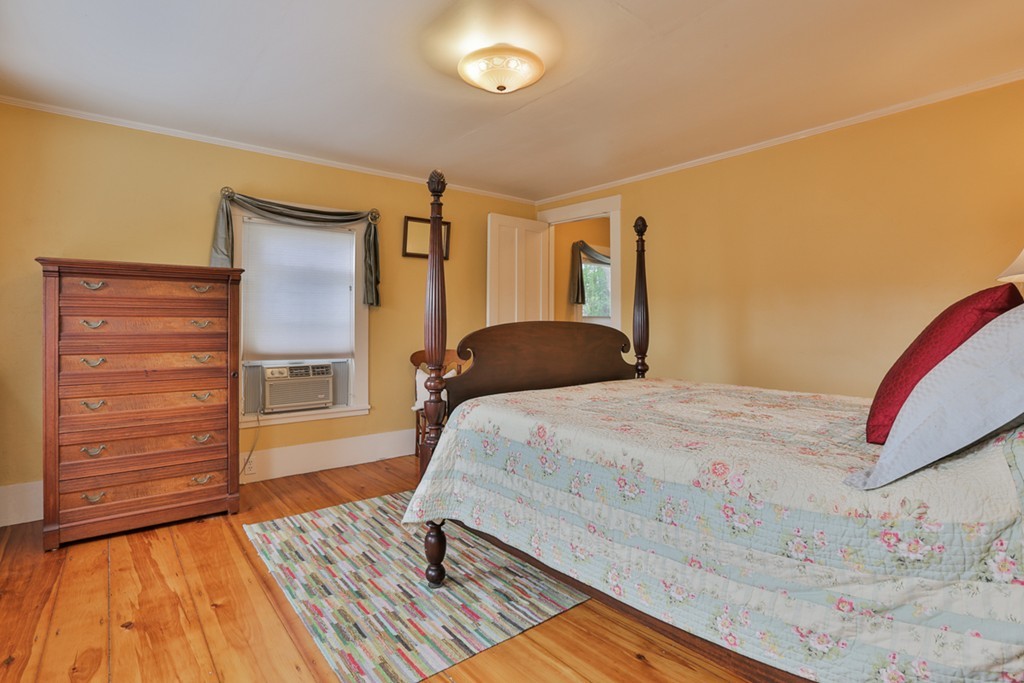 74 River Road Merrimac, MA 01860 - Photo 22 of 29 a bedroom with a bed and a mirror