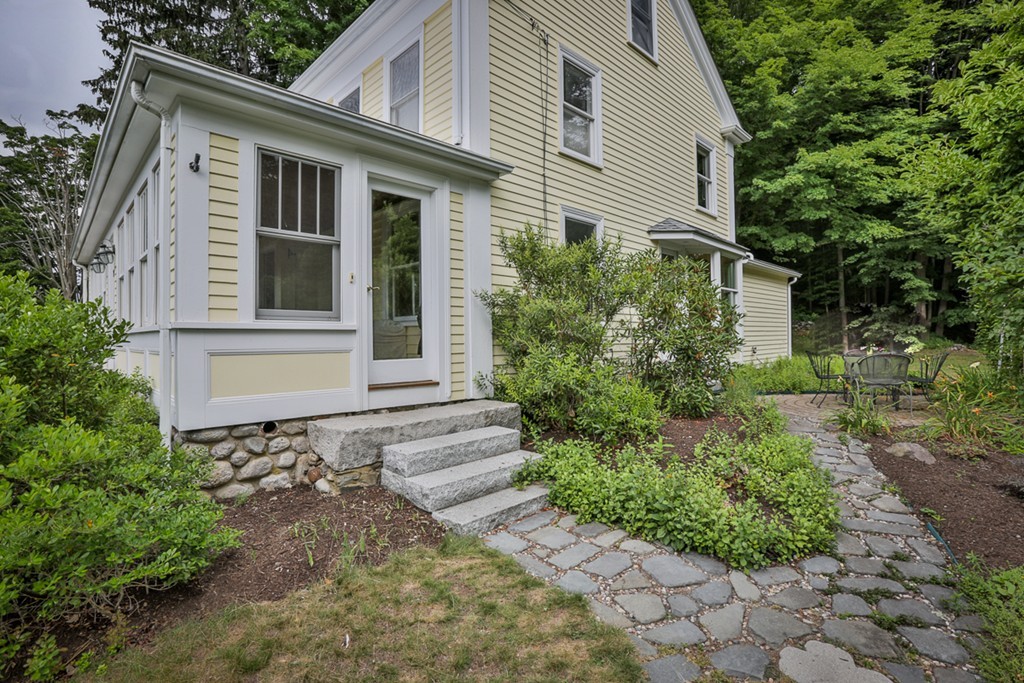 74 River Road Merrimac, MA 01860 - Photo 3 of 29 a front view of a house with garden
