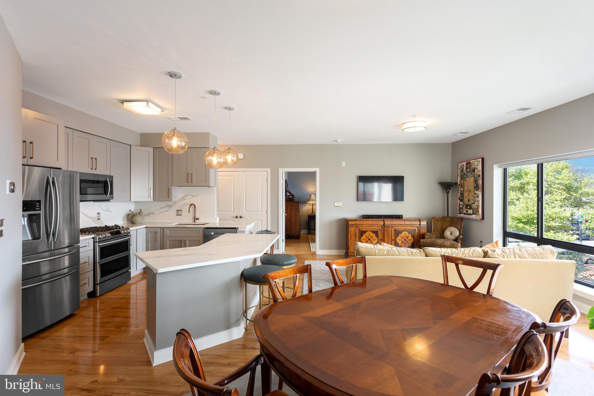 8005 13th Street, Unit 305 Silver Spring, MD 20910 - Photo 26 of 40 a large kitchen with a table and chairs