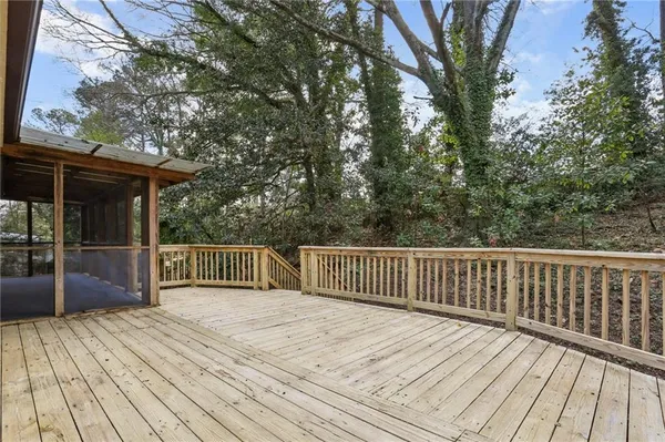 a view of backyard with deck and wooden floor