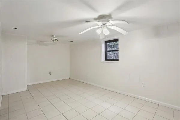 an empty room with a fan and a fan