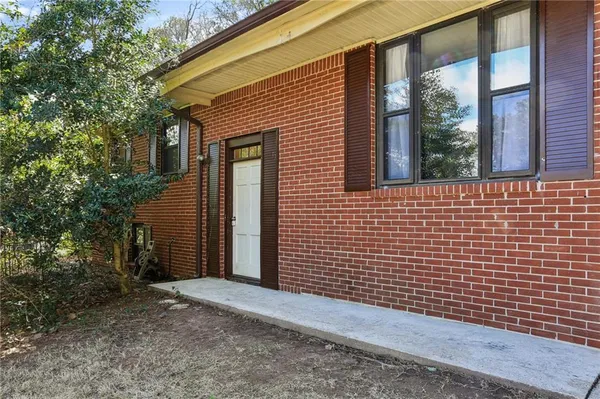 a view of a brick house with a large windows