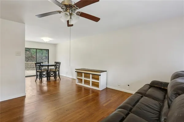 a view of a livingroom with furniture and a floor to ceiling window
