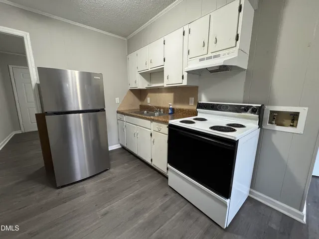 a kitchen with white cabinets and white stainless steel appliances