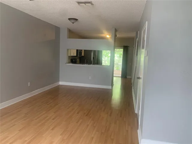 a view of hallway with wooden floor