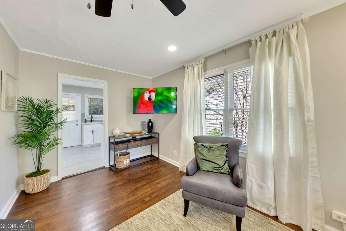 a living room with furniture and a potted plant