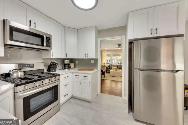 a kitchen with a stove microwave and refrigerator