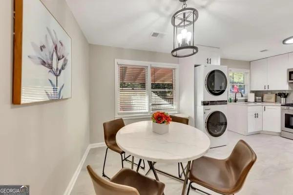a view of a dining room with furniture and chandelier