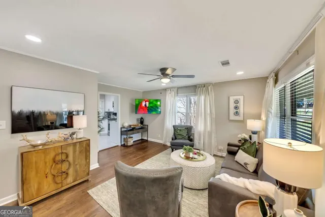 a living room with furniture and a flat screen tv