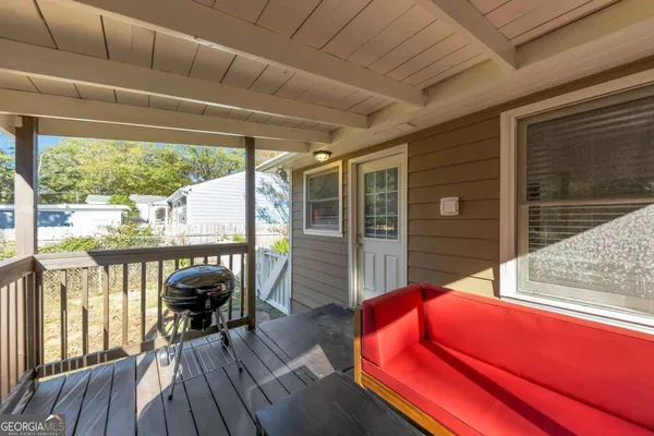 a balcony with furniture and wooden floor