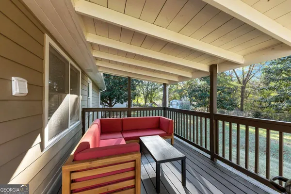 a balcony with chairs and wooden floor