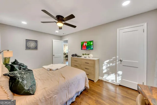 a bedroom with a bed and wooden floor