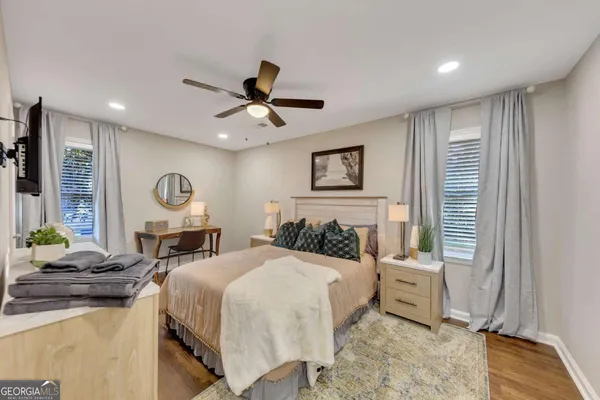 a bedroom with a bed a mirror and a window