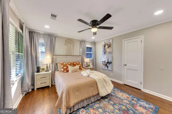 a bedroom with a large bed and a window