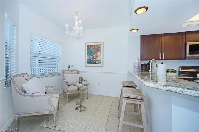 a living room with furniture and a dining table