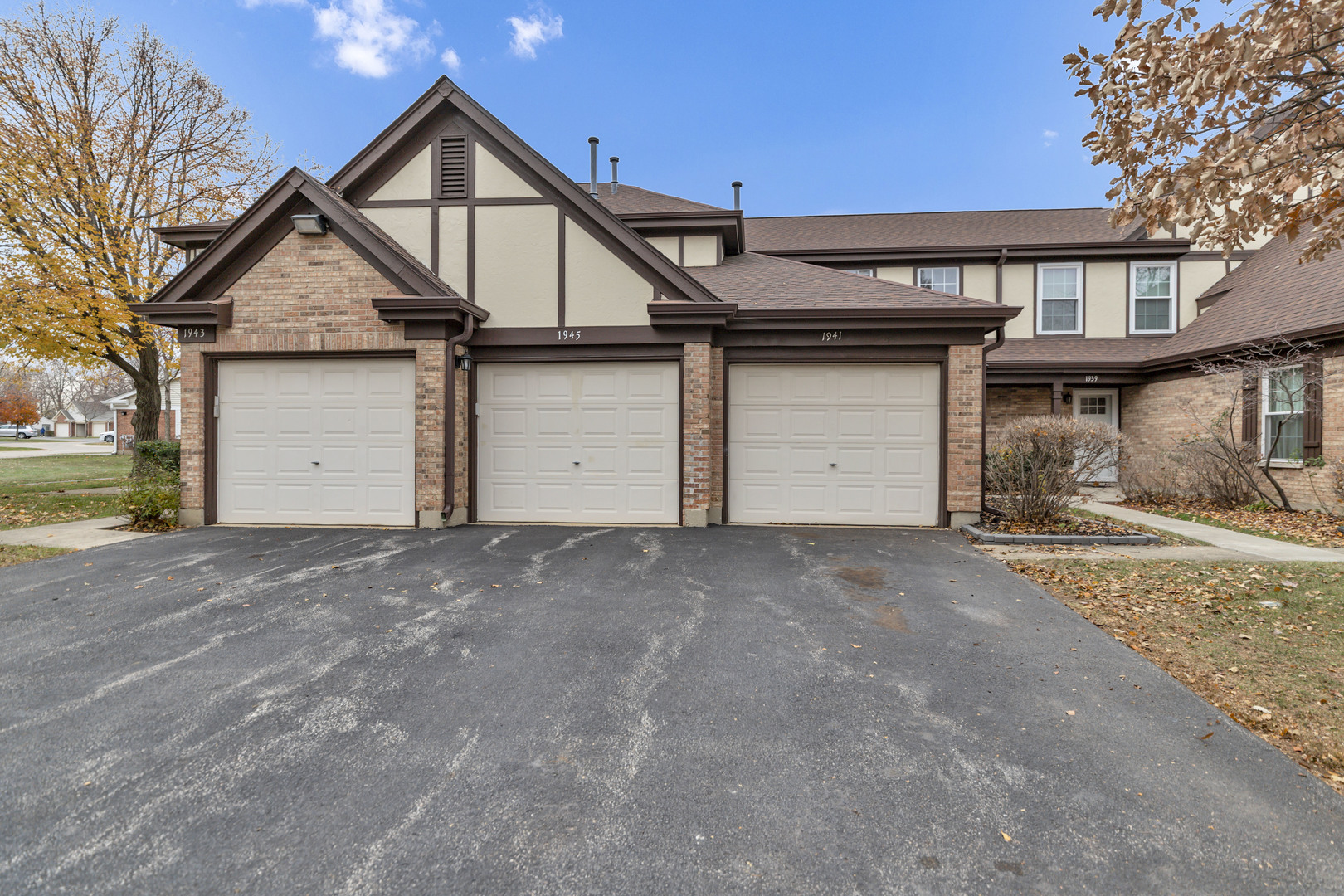 1941 Quaker Hollow Lane, Unit 1941 Streamwood, IL 60107 - Photo 1 of 13 a view of a house with a yard and garage