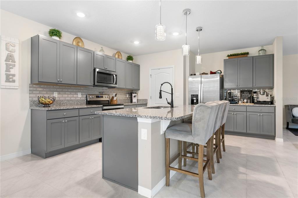 225 Sunset Point Drive Ormond Beach, FL 32174 - Photo 12 of 53 a kitchen with a sink a microwave and cabinets