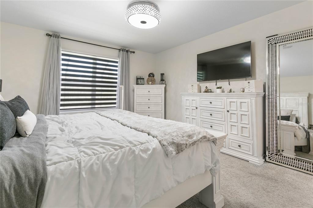 225 Sunset Point Drive Ormond Beach, FL 32174 - Photo 18 of 53 a bedroom with a bed and a flat screen tv