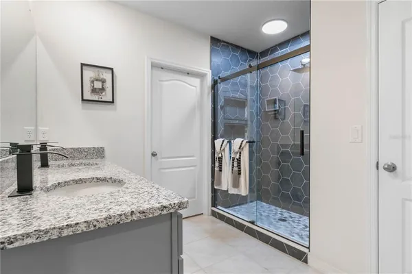 a bathroom with a shower and a sink