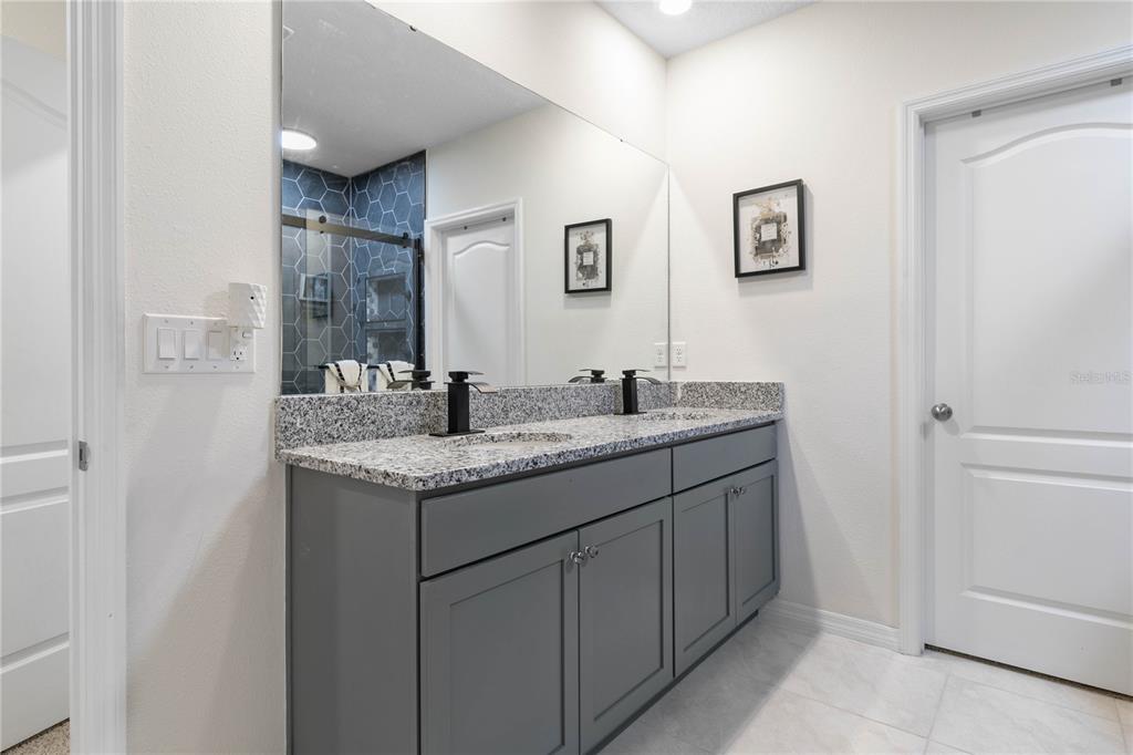 225 Sunset Point Drive Ormond Beach, FL 32174 - Photo 21 of 53 a bathroom with a granite countertop sink and a mirror
