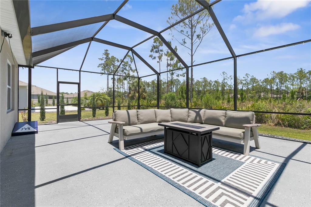 225 Sunset Point Drive Ormond Beach, FL 32174 - Photo 39 of 53 a view of a patio with couches and a table