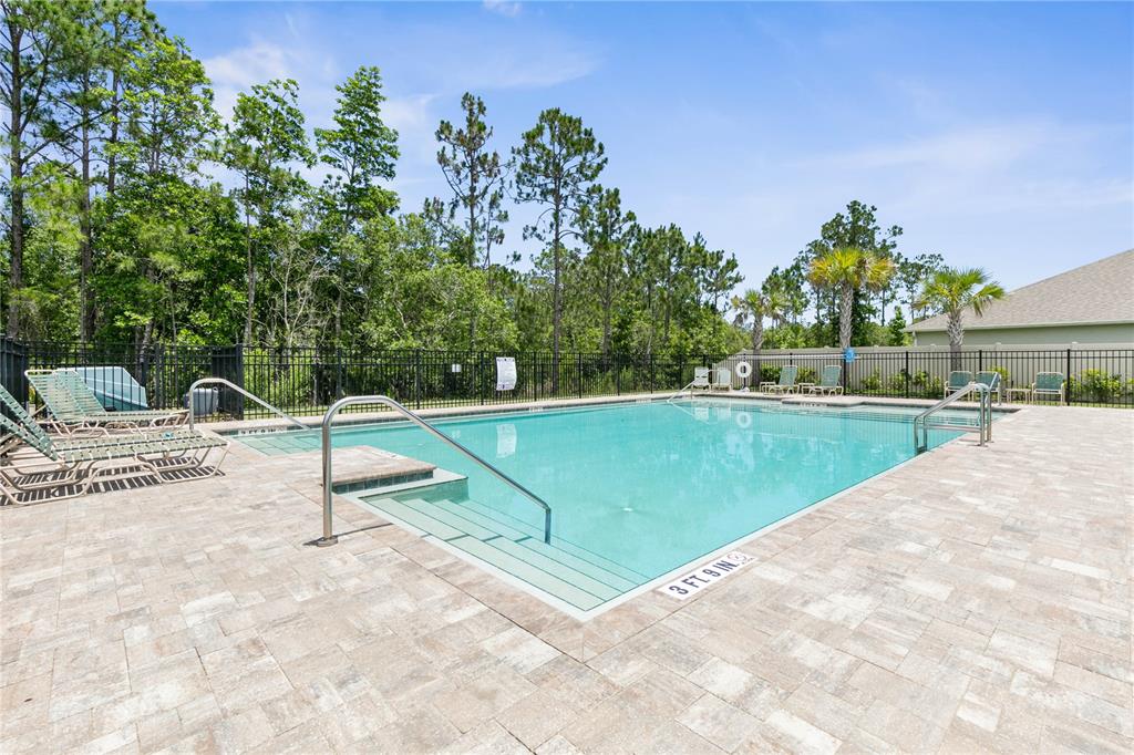 225 Sunset Point Drive Ormond Beach, FL 32174 - Photo 49 of 53 a view of a swimming pool with a yard and sitting area