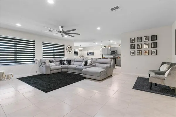 a living room with furniture two windows and a table
