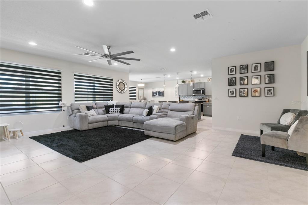 225 Sunset Point Drive Ormond Beach, FL 32174 - Photo 5 of 53 a living room with furniture two windows and a table