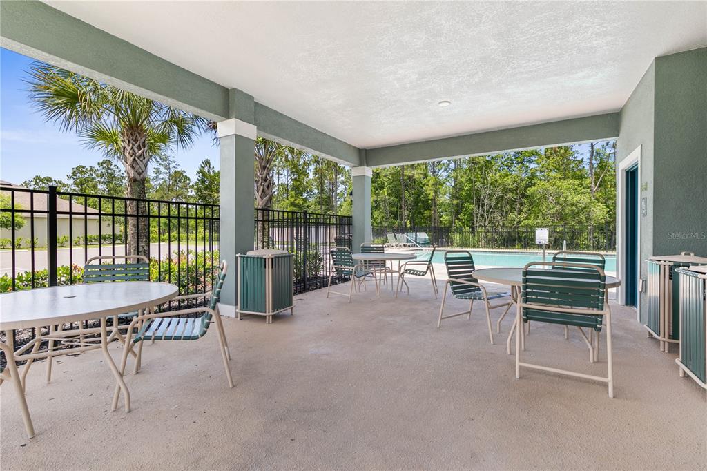 225 Sunset Point Drive Ormond Beach, FL 32174 - Photo 52 of 53 a dining room with furniture and a floor to ceiling window