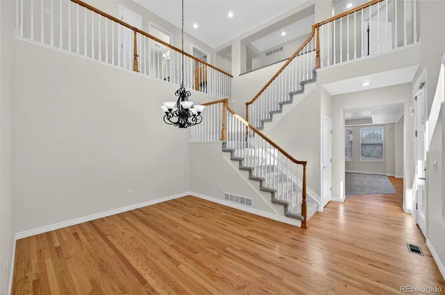 a view of entryway with wooden floor and stairs