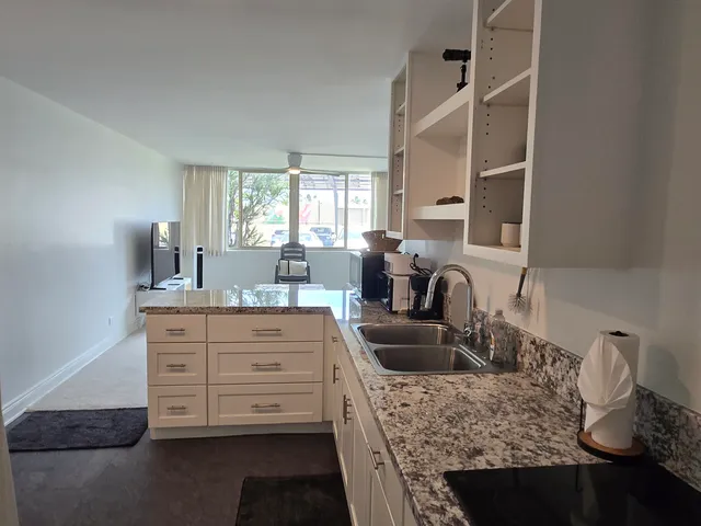 a kitchen with cabinets appliances and windows