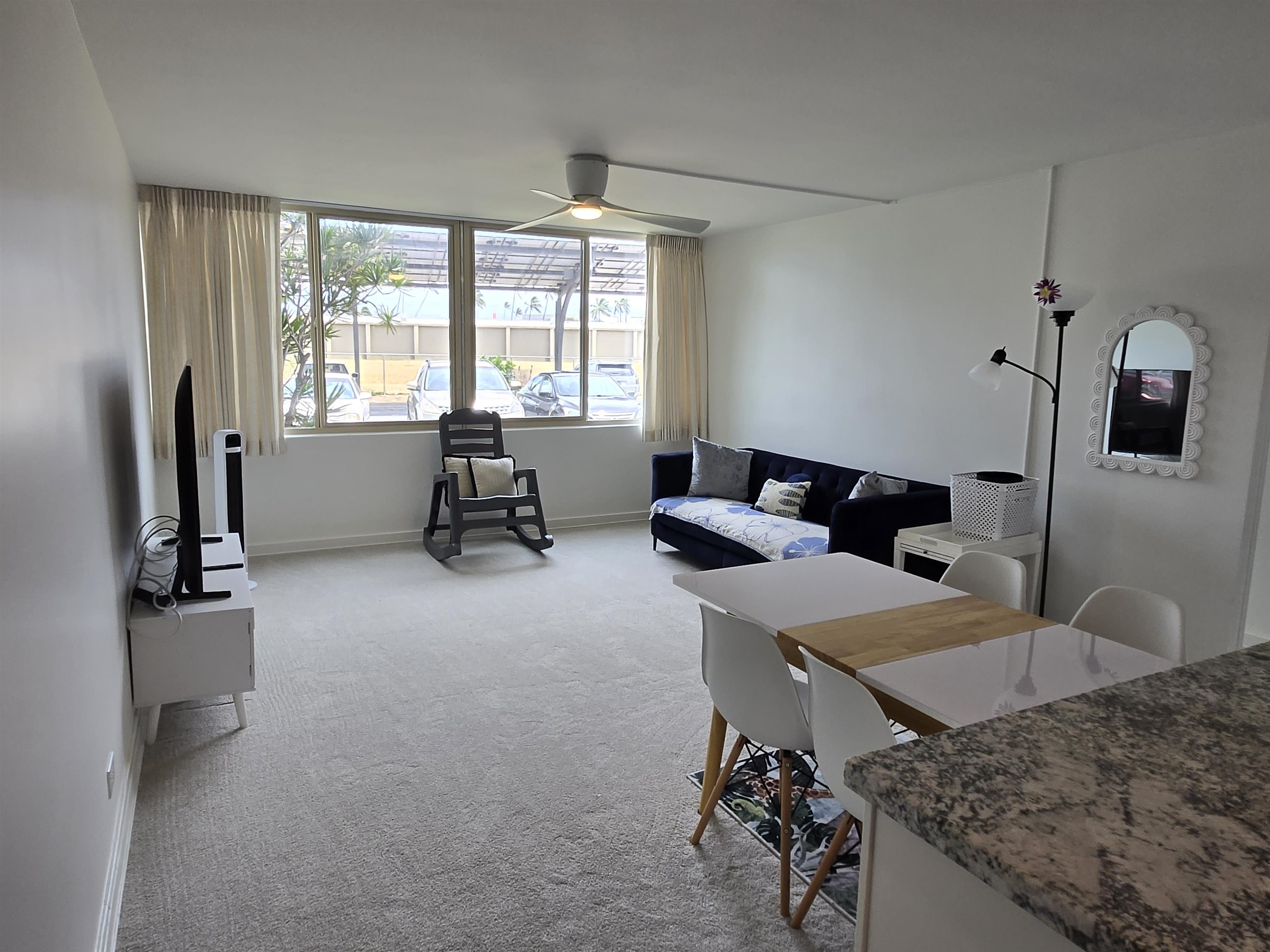 111 Kahului Beach Road, Unit B114 Kahului, HI 96732 - Photo 3 of 11 a living room with furniture and a flat screen tv
