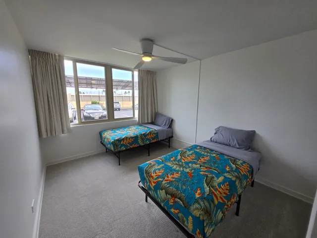 a bedroom with two beds and a window