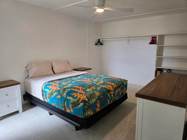 a bedroom with a bed and a dresser