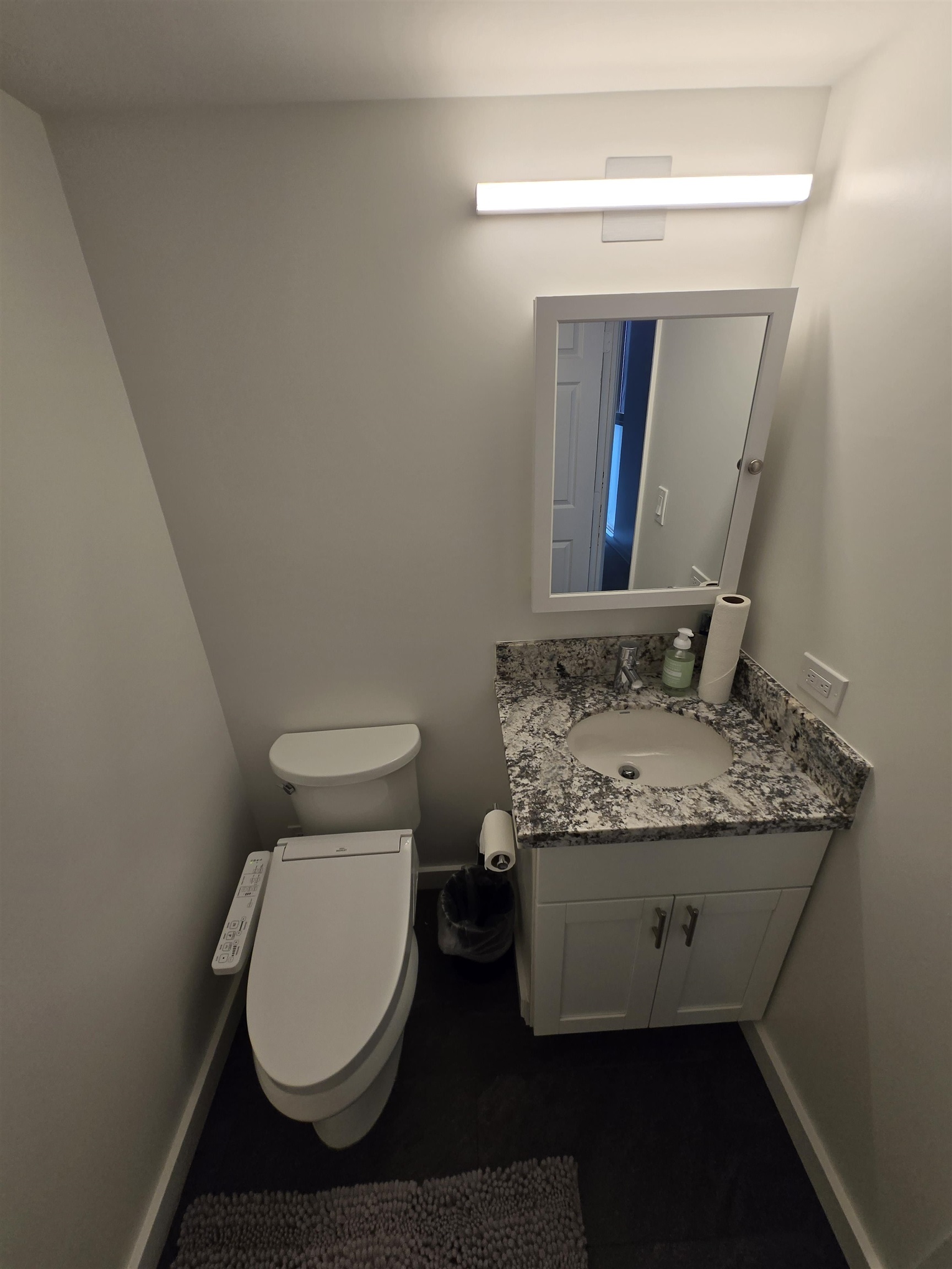 111 Kahului Beach Road, Unit B114 Kahului, HI 96732 - Photo 10 of 11 a bathroom with a granite countertop toilet and a sink