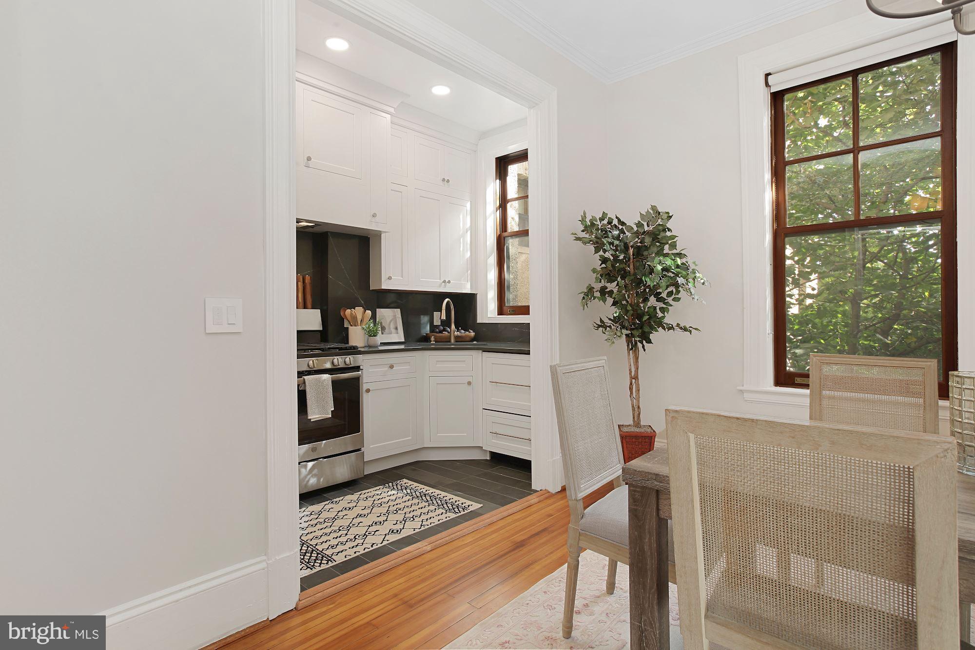 2853 Ontario Road Northwest, Unit 210 Washington, DC 20009 - Photo 12 of 28 a kitchen with white cabinets and window